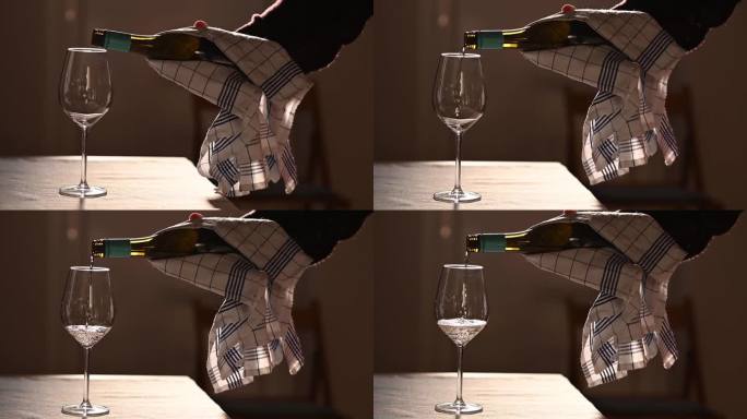 把白葡萄酒倒进靠在木桌上的玻璃杯里。饮料