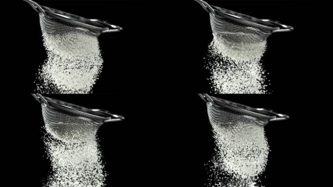 面粉用筛子筛过。黑色背景。用高速摄像机拍摄，每秒1000帧。