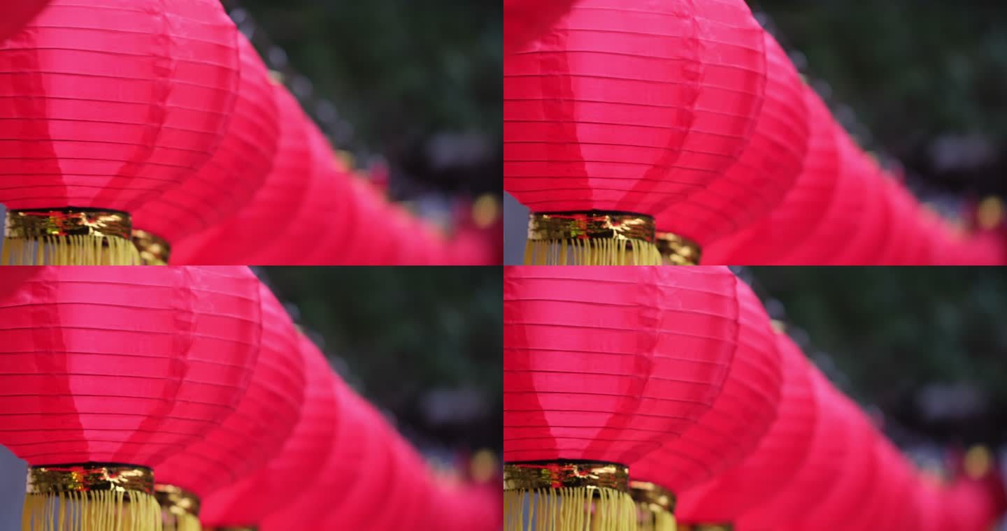 一排中国传统的红色纸灯笼在风中摇摆