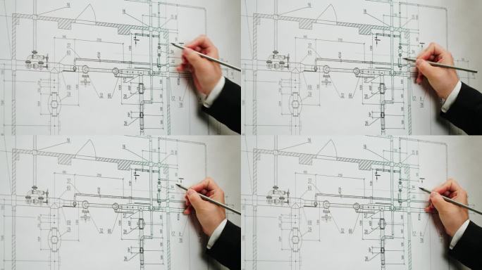 建筑设计师与计划蓝图的特写。专业的方案展示工程师，室内设计师，建筑房屋设计，建筑制图。