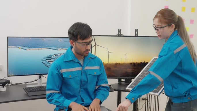 工程师在办公室用电脑屏幕讨论太阳能电池板规划的镜头。
