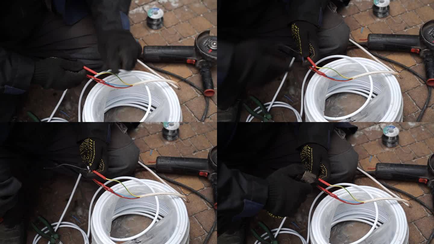 电工用烙铁焊接电线。烙铁，接线修理。师傅用气焊铁焊接电线