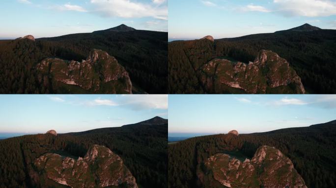 日落时分，无人机在法国上卢瓦尔省的“凹痕”周围拍摄，背景是梅泽茨山