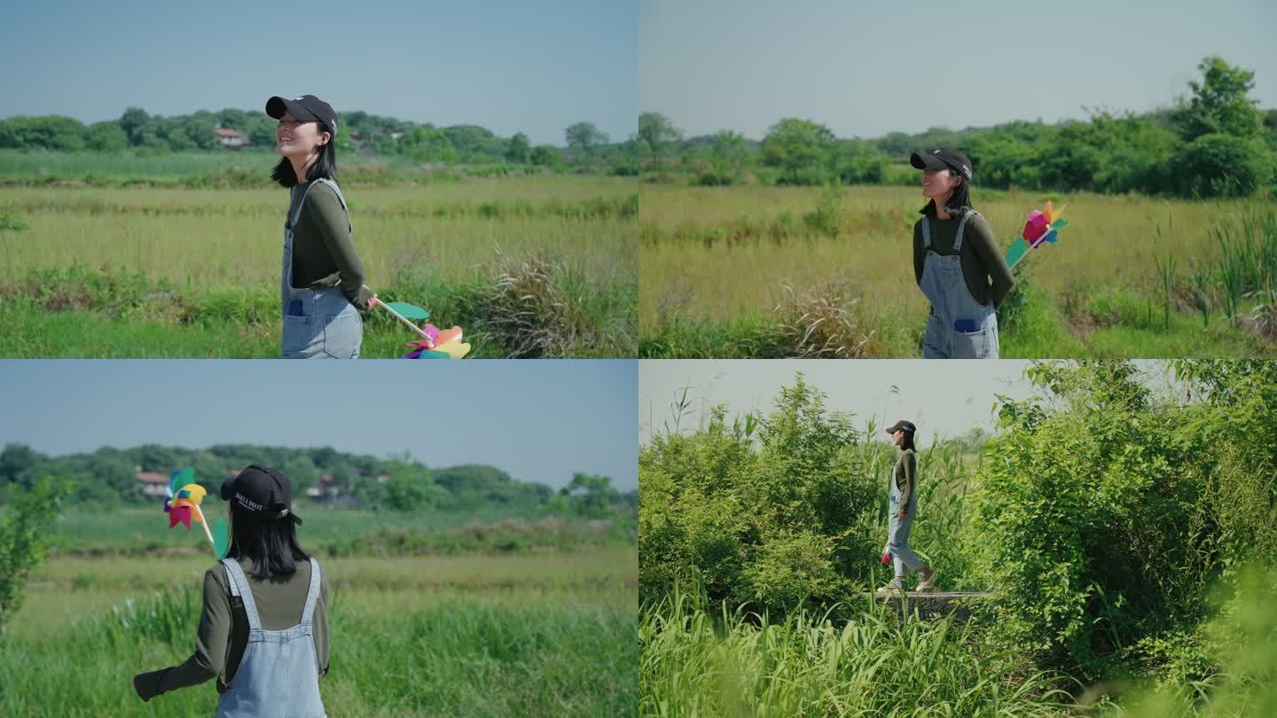 女生在乡村风景拿着风车散步玩耍治愈系风景