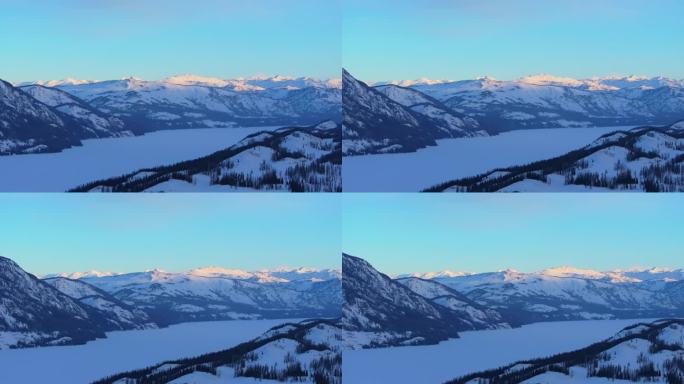 新疆阿勒泰冬季喀纳斯湖雪山水墨画雪景日出