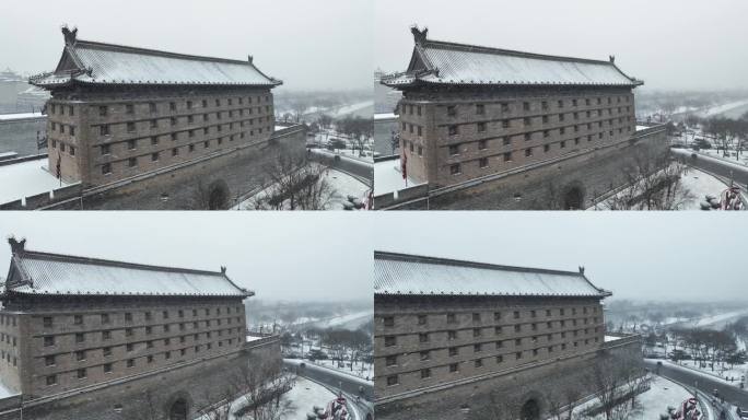 航拍陕西省西安市大雪中的西安安远门古城墙