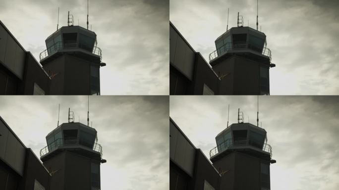 低角度看机场塔台对天空中的云。空中交通管制，现代建筑的剪影。机场及航空概念