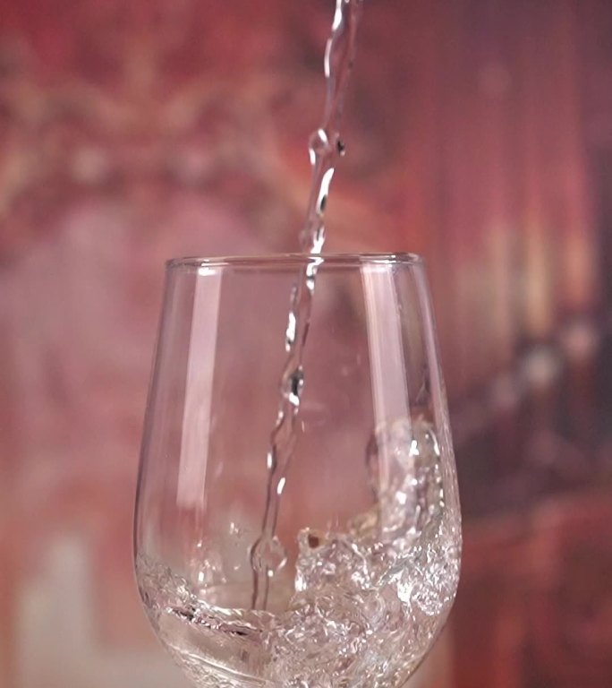 往高脚杯倒透明液体水酒香槟高清