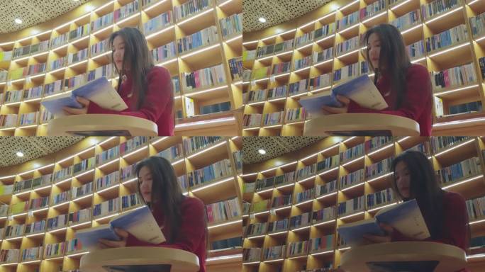 正在图书馆的灯光下看书的亚洲女性