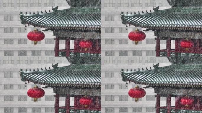 中国陕西西安钟楼挂着红灯笼在大雪中飘动