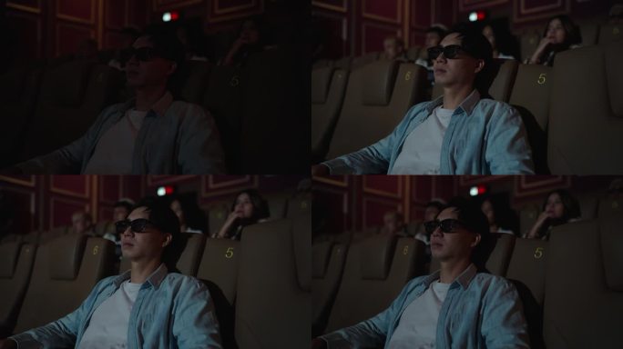 一名男子在电影院沉浸在恐怖的电影体验中。