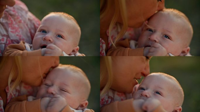 日落时分，快乐的妈妈亲吻着快乐的小男孩的额头