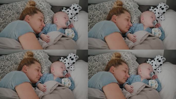 妈妈和宝宝在家里的床上睡觉的高角度手持拍摄