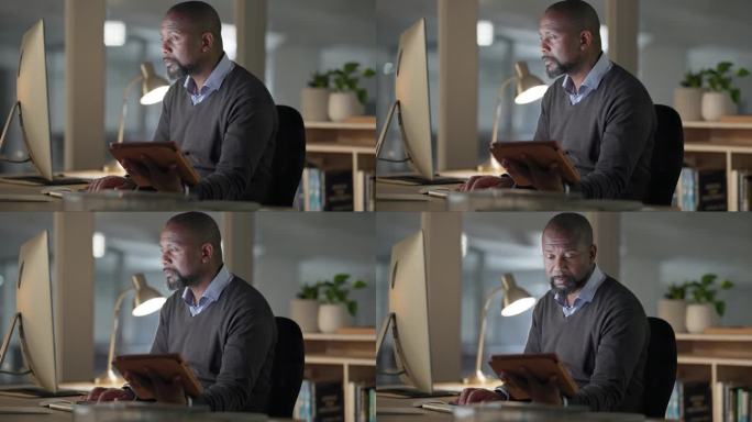 黑人，为了项目截止日期，研究或在办公室建立人际关系，晚上在电脑前用平板电脑。非洲商人在工作场所的办公