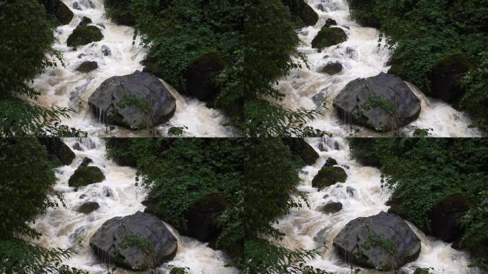 雨季的瀑布。峡谷之间湍急的瀑布河。大雨过后，泥土正在往下移。巨大翻滚的棕色浑水。4k慢动作镜头b滚拍