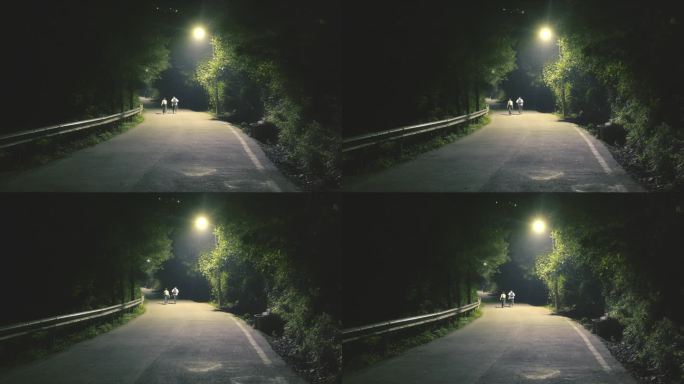 夜晚马路灯光下的行人孤独氛围寂静城市小路