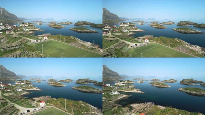 无人机的视角揭示了著名的亨宁斯维尔体育场在罗弗敦崎岖的美丽之中，传统的鳕鱼烘干架，以及挪威海分散的岛