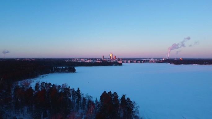 无人机在冰雪上拍摄，背景是赫尔辛基Kalasatama的天际线