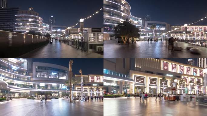 夜间照明迪拜市著名的市中心购物中心喷泉拥挤的广场步行全景4k延时阿联酋