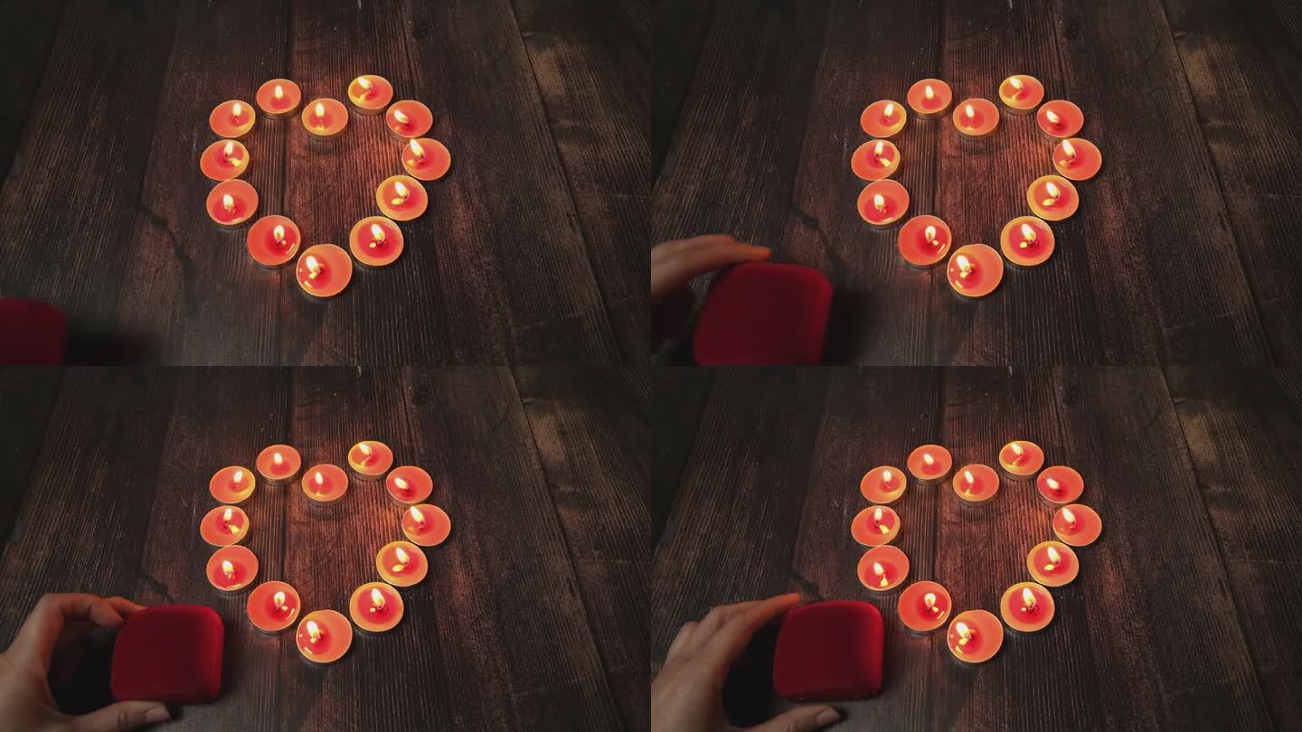 红色的爱情蜡烛，浪漫的木桌上浪漫的晚餐。一个可爱的“我爱你”情人节卡片的概念。情人节