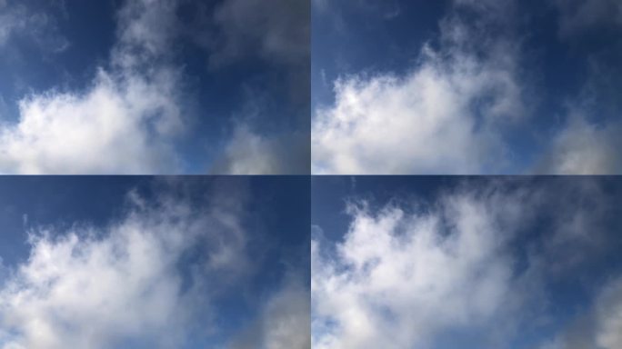 蓝天的垂直视图，缕缕白云从画面左下方斜向右上方移动