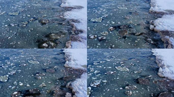 冬季早晨，波罗的海的冰天雪地的鸟瞰图。冰封的波罗的海上的浮冰。冰冷厚重的海水混合着雪和冰的波浪拍打着
