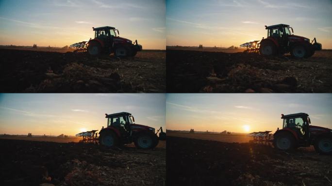 农艺师在日落时分驾驶拖拉机耕作有机农场