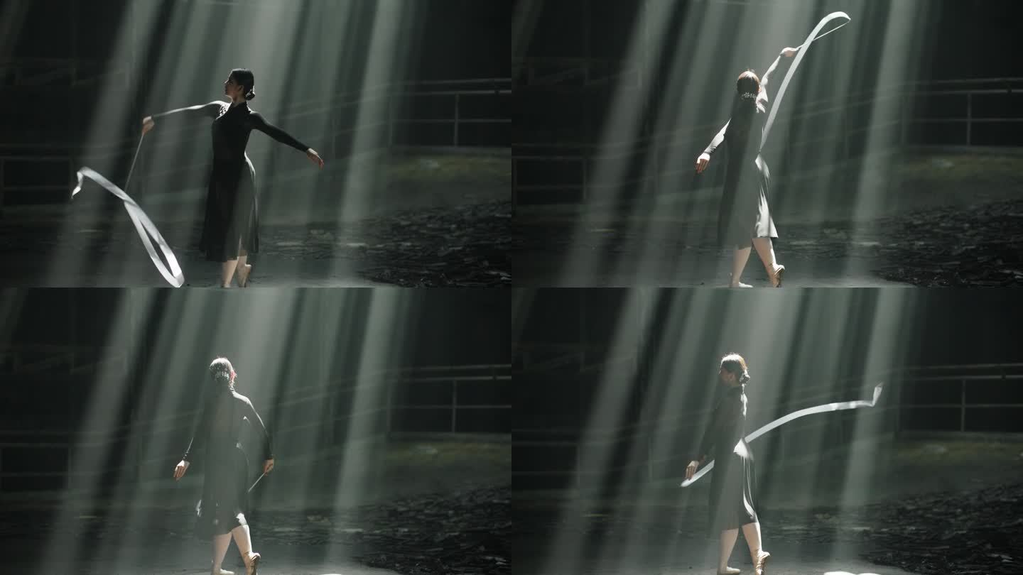 在黑暗的大厅里，芭蕾舞女演员在戏剧性的灯光下用白丝带表演的剪影。