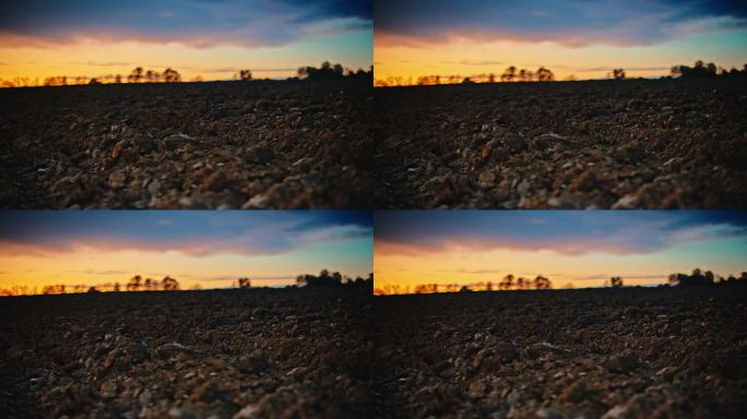 多莉拍摄的泥土地面对多云的天空在日落期间