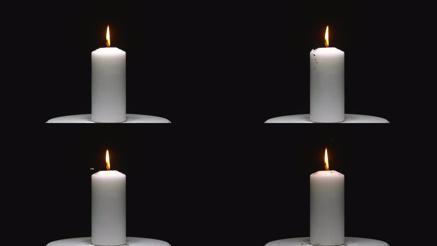 令人着迷的库存镜头:燃烧的蜡烛，纸张在黑色色度键背景下轻轻点燃。理想的动态，大气的视觉效果