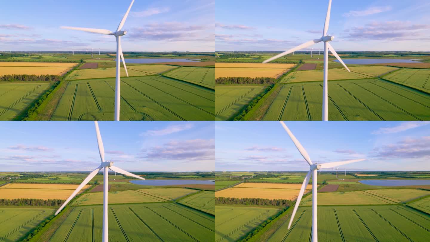 航拍，特写:农村地区风力发电场旋转的白色风车叶片