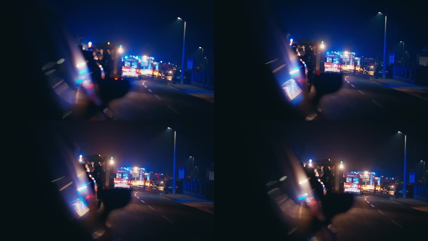 SLO MO消防车在夜晚用闪烁的蓝色灯光和刺耳的警报器刺穿黑暗