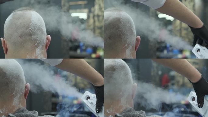 一个戴着黑色手套的理发师正从蒸发器中喷出一股热气