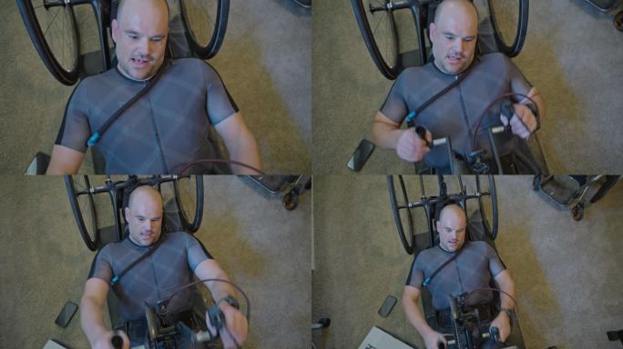 一名身体残疾的男子在家庭健身房使用手动自行车