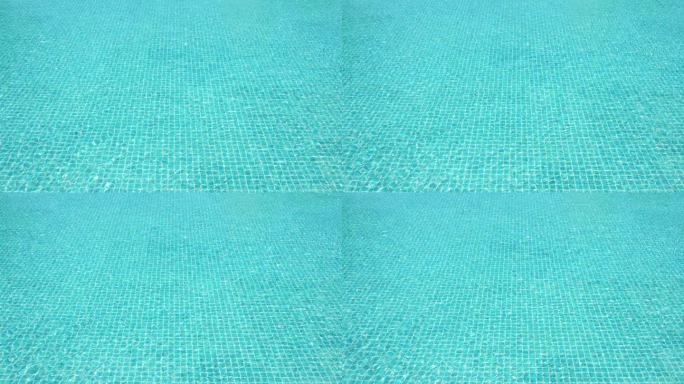 蓝色泳池上的水波慢动作，美丽的泳池纹理背景