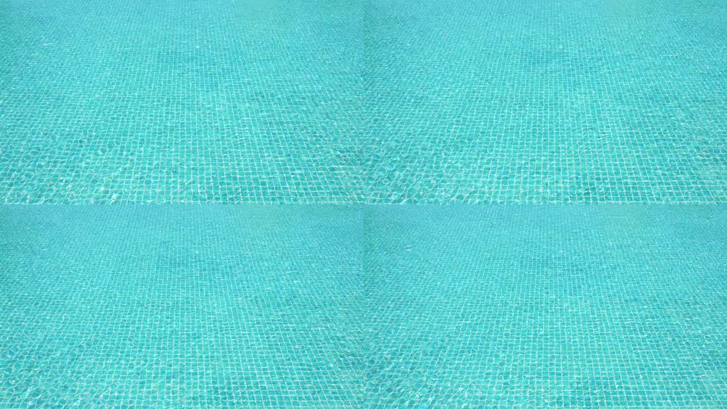 蓝色泳池上的水波慢动作，美丽的泳池纹理背景