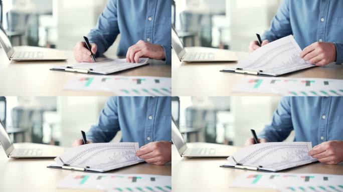 一个男人的手在商务办公室的办公桌前签署文件的特写。