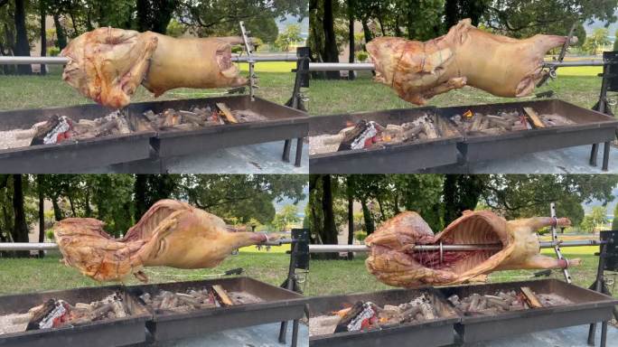 整只羊的胴体在烤肉架上缓慢旋转，完美地烤出了自然的炭火