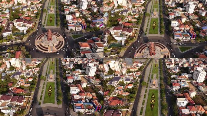 柬埔寨金边市中心西哈努克大道上的独立纪念碑上方的无人机镜头。摄像机正朝1-2方向移动