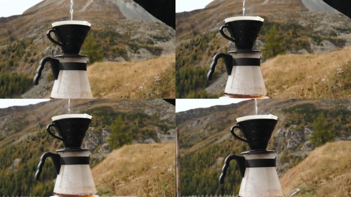 旅行者制作过滤咖啡，把水倒在磨碎的咖啡豆里，对着山景