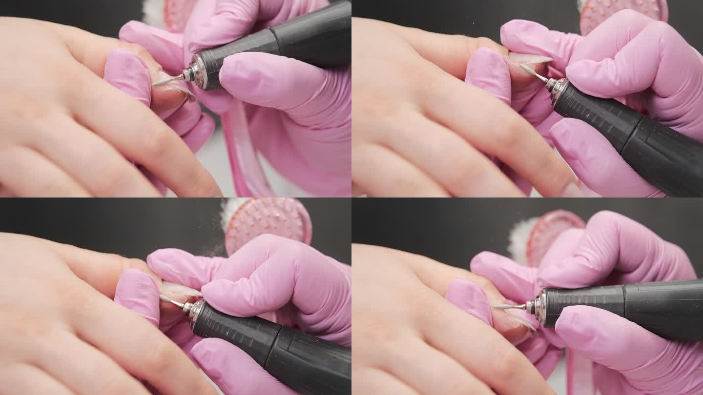 美甲师在美甲沙龙用电动指甲锉修指甲角质层的特写。