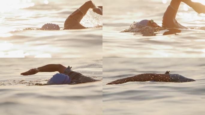 女子在夕阳下度假时在海里游泳的慢镜头镜头。一个坚定的女人在游泳。