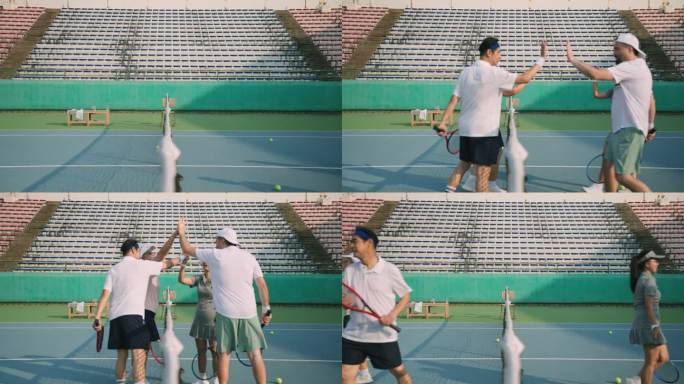 一群退休的老朋友在早上一起在网球场打网球混合双打，玩得很开心。他们都相对站在网前，手握球拍拍在一起。