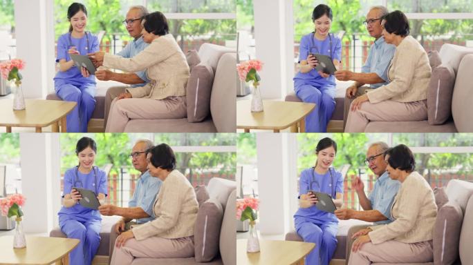 专业的亚洲护士或医生在老年保健中心诊所或医院的客厅为老年夫妇使用片剂进行咨询和辅助。