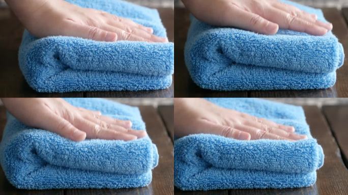 一段蓝色浴巾被手工揉松和按压的视频。