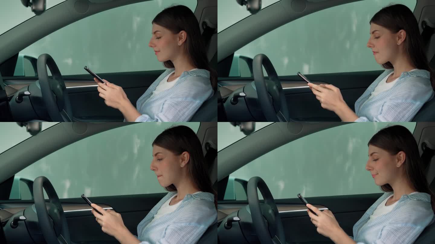 有环保意识的夫妇坐在驾驶座上拿着空白的copyspace屏幕手机。高举