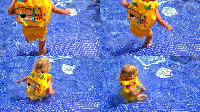 一个穿着背心的孩子在游泳池里游泳。有选择性的重点。
