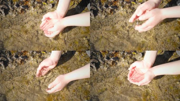 在一个阳光明媚的日子里，孩子们的手触摸着石龛里的清水。