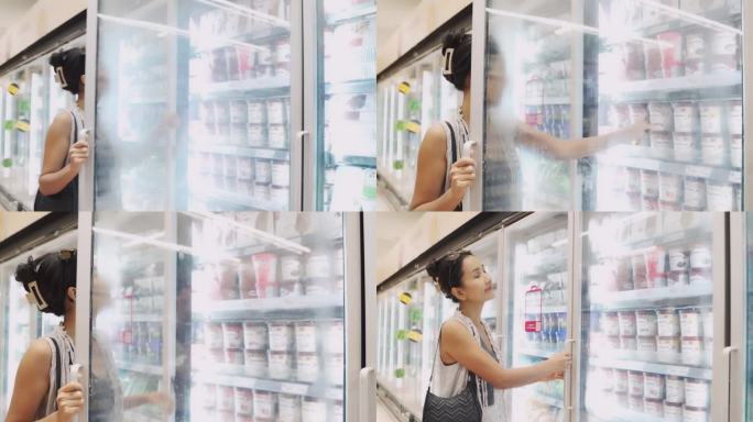 美丽的亚洲女人选择和购买牛奶在杂货店超市。