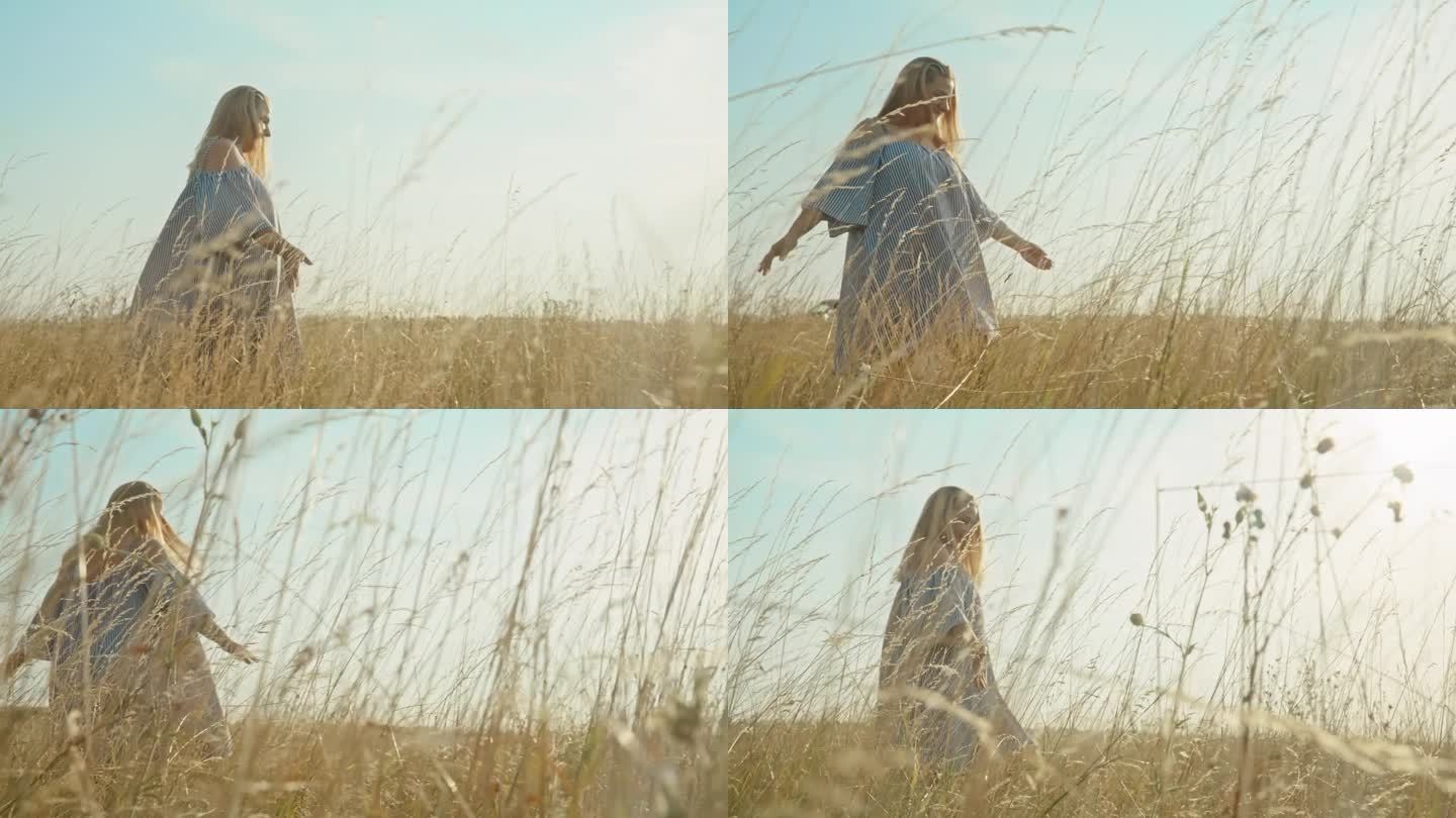 自然的和谐:女人在金色草地上的宁静漫步